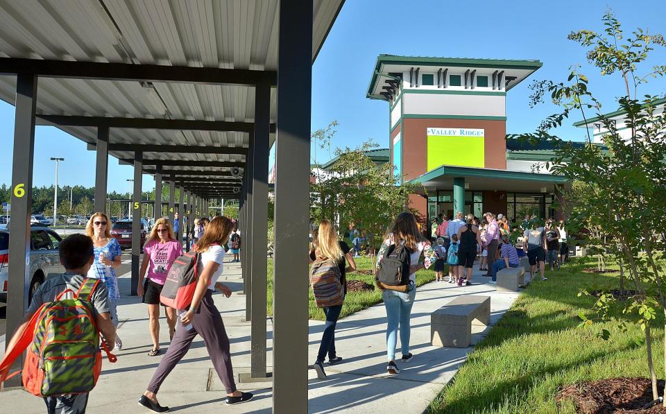Parents and teacherswalk into Valley Ridge Academy in this 2014 photo from the first day of school at the kindergarten-through-eighth grade school in Ponte Vedra in St. Johns County.