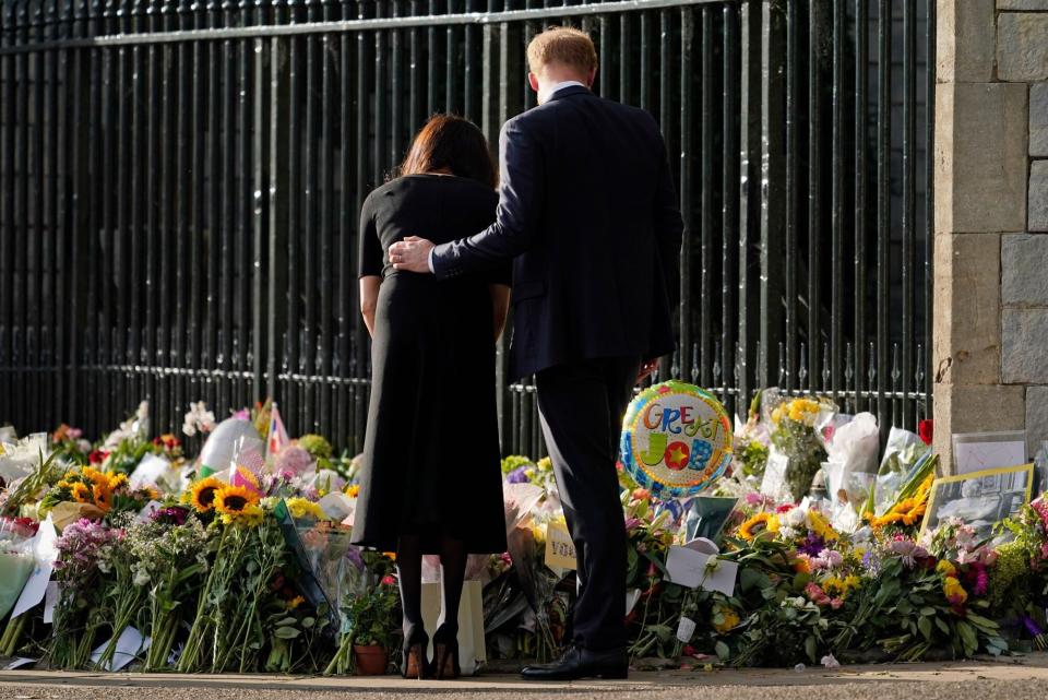 Mandatory Credit: Photo by Alberto Pezzali/AP/Shutterstock (13381171a) Britain's Prince Harry and Meghan, Duchess of Sussex view the floral tributes for the late Queen Elizabeth II outside Windsor Castle, in Windsor, England Royals, Windsor, United Kingdom - 10 Sep 2022