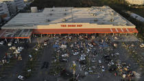 People walk away with items taken from stores after Hurricane Otis ripped through Acapulco, Mexico, Thursday, Oct. 26, 2023. Many residents were taking basic items from stores to survive. Others left with pricier goods, in widespread rampages through the area's stores. (AP Photo/Felix Marquez)