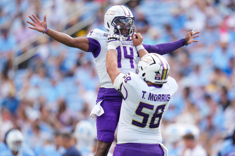 CHAPEL HILL, NORTH CAROLINA – SEPTEMBER 21: Alonza Barnett III #14 celebrates with Tanner Morris #58 of the James Madison Dukes after throwing a touchdown against the North Carolina Tar Heels during the first half of the game at Kenan Memorial Stadium on September 21, 2024 in Chapel Hill, North Carolina. (Photo by Grant Halverson/Getty Images)