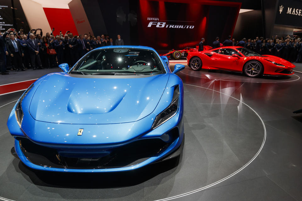 CAPTION CORRECTS CAR NAME Visitors look at the new 'Ferrari F8 Tributo' during the press day at the '89th Geneva International Motor Show' in Geneva, Switzerland, Tuesday, March 05, 2019. The 'Geneva International Motor Show' takes place in Switzerland from March 7 until March 17, 2019. Automakers are rolling out new electric and hybrid models at the show as they get ready to meet tougher emissions requirements in Europe - while not forgetting the profitable and popular SUVs and SUV-like crossovers. (Cyril Zingaro/Keystone via AP)