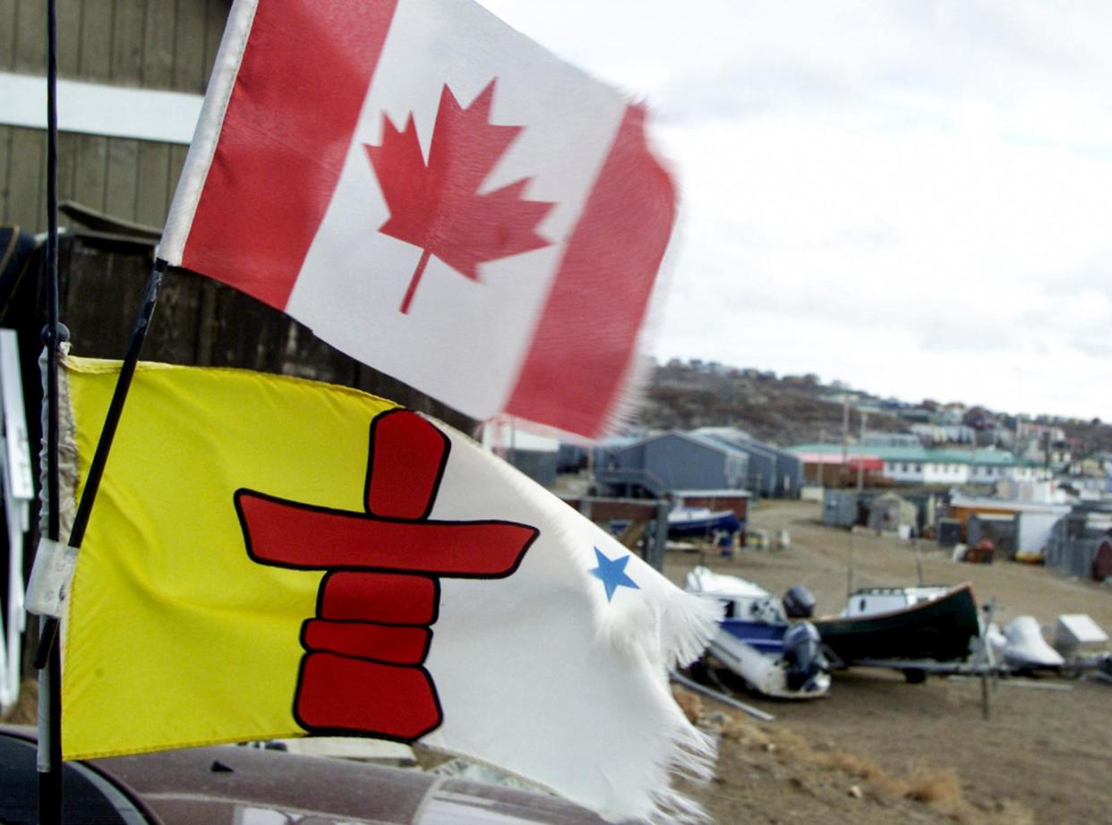 <span>The Nunavut and Canadian flags.</span><span>Photograph: Jim Young/Reuters</span>