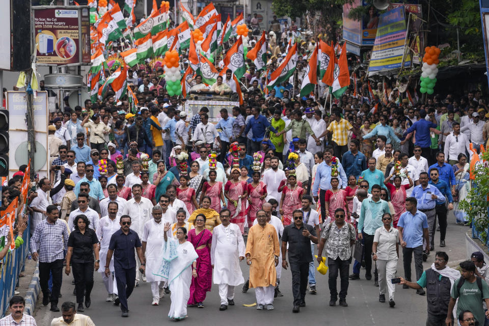 FILE-West Bengal state Chief Minister Mamata Banerjee, front, hand raised, with supporters of Trinamool Congress Party walks during a road show ahead of seventh and last phase of election in Kolkata, India, Thursday, May 30, 2024. (AP Photo/Bikas Das, file)