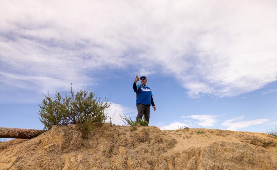 A hiker climbed to get a bird's eye view of Dodgers Blue Hiking Crew attendees.