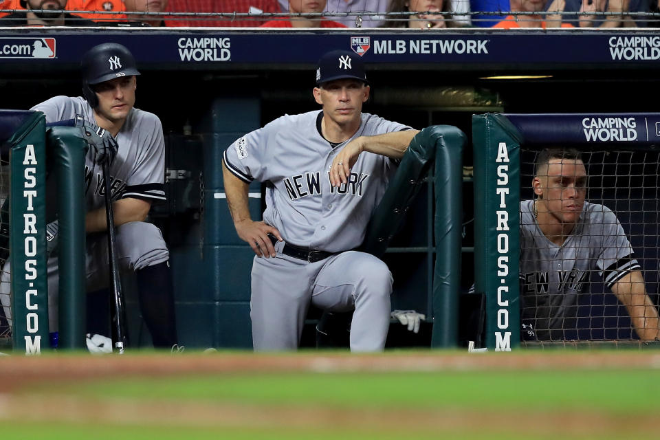 HOUSTON, TX - OCTOBER 21:  Greg Bird #33, manager Joe Girardi #28 and Aaron Judge #99 of the New York Yankees look on from the dugout during the sixth inning against the Houston Astros in Game Seven of the American League Championship Series at Minute Maid Park on October 21, 2017 in Houston, Texas.  (Photo by Ronald Martinez/Getty Images)