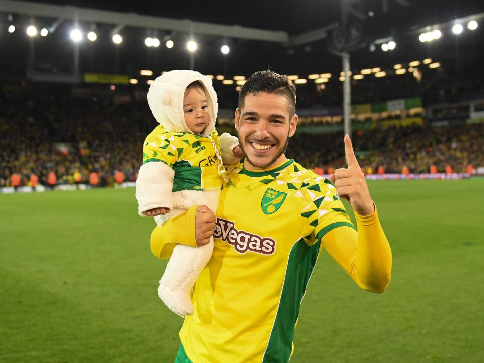 <p>Emiliano Buendia celebrates with his son, Thiago, after Norwich secure promotion in 2019</p> (Rex)