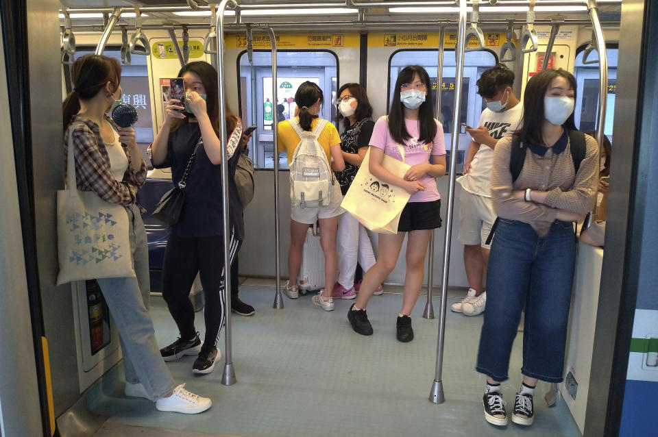 Passengers wear face masks to protect against the spread of the coronavirus at a train in Taipei, Taiwan, Saturday, June 27, 2020. (AP Photo/Chiang Ying-ying)