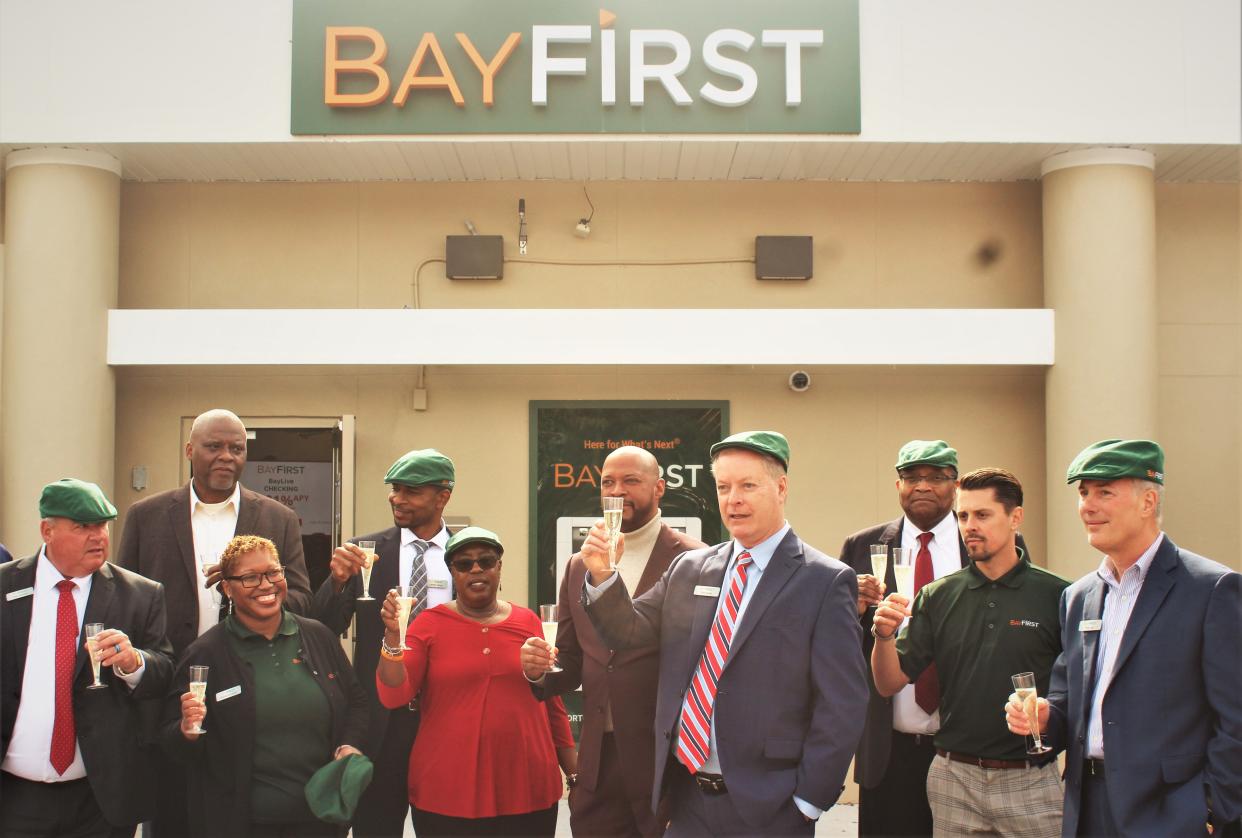 BayFirst National Bank team members, including BayFirst BayFirst executive vice president & chief lending officer Tom Quale, along with Newtown community leaders and residents,celebrate the opening and expansion of the Newtown BayFirst branch.
