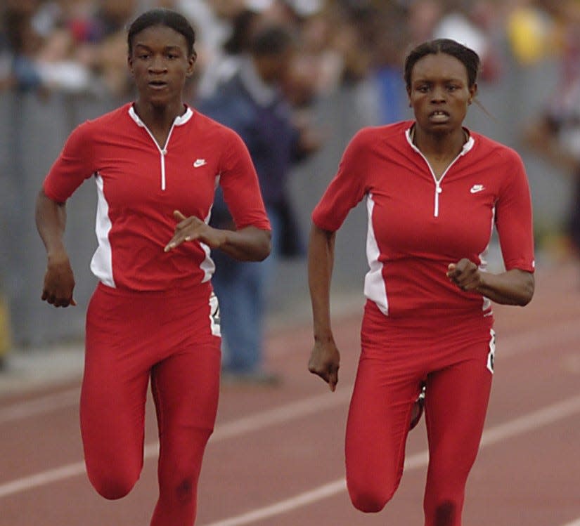 Glasgow High School's Sahara Parks (left) is edged out for first place by teammate Jernail Hayes as they head for the finish line in the 100 meter dash final in the Glasgow High School Invitational, Saturday, April 23, 2005 at Glasgow High School.