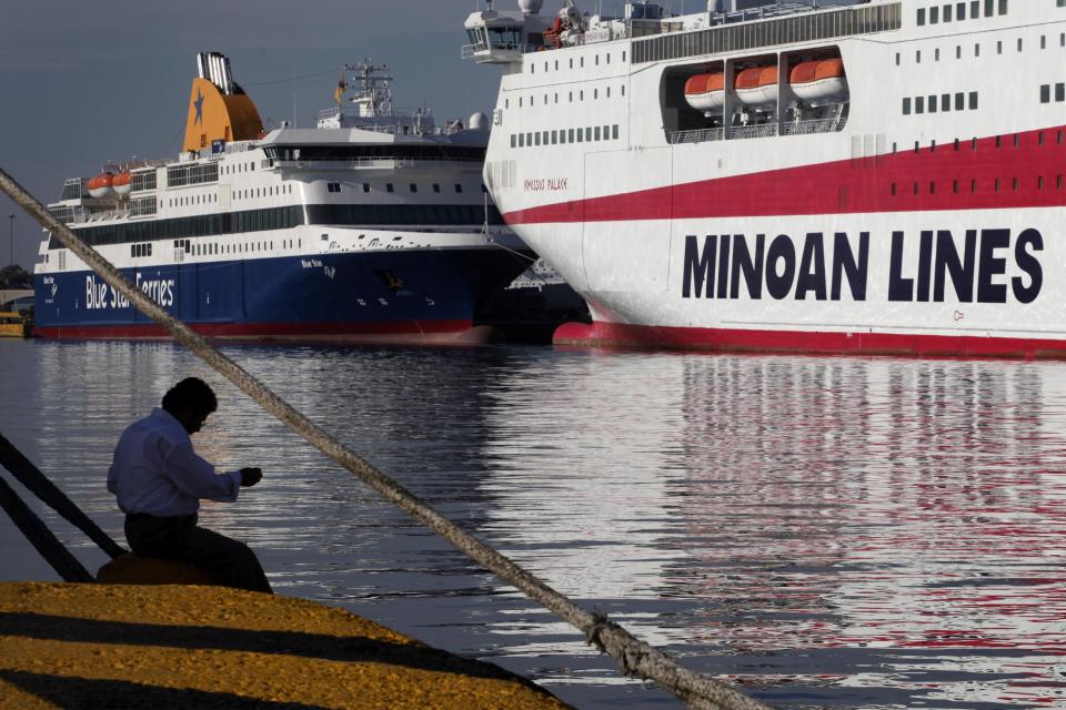 A man fishes in front of docked ships at the port of Piraeus, near Athens during a 48-hour nationwide general strike on Tuesday, Nov. 6, 2012. Greece's unions are holding their third general strike in six weeks in the hope of persuading politicians not to back a major new austerity program that will commit the country to further hardship. (AP Photo/Petros Giannakouris)