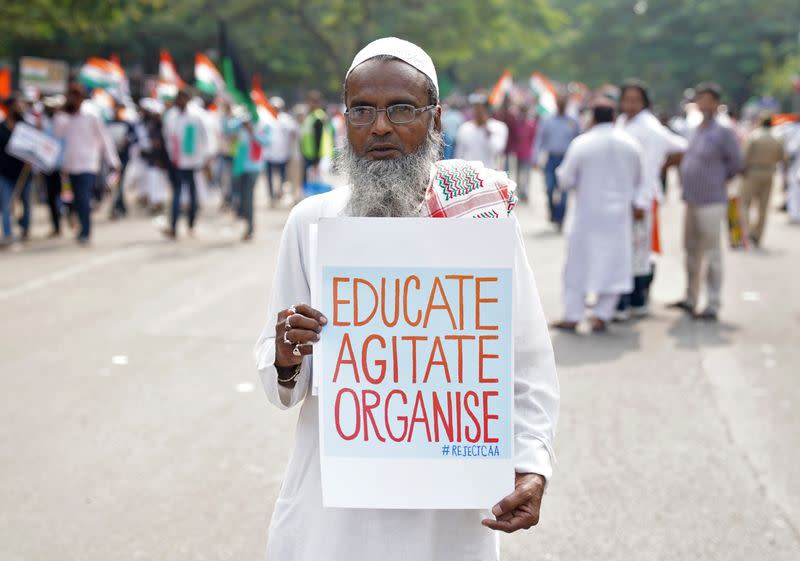 A demonstrator displays a placard as he attends a protest rally against a new citizenship law, in Hyderabad