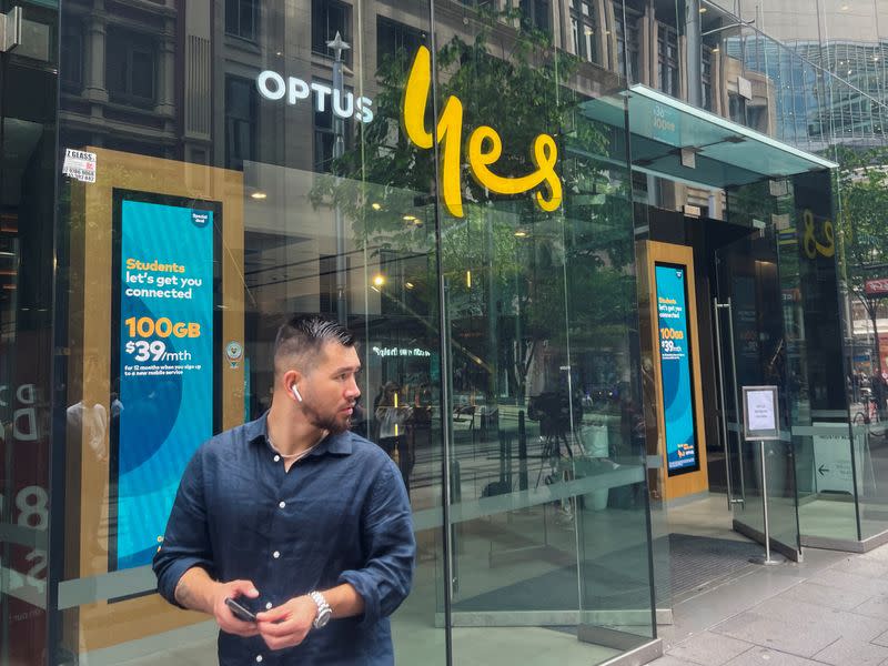 A person walks past an Optus shop in Sydney