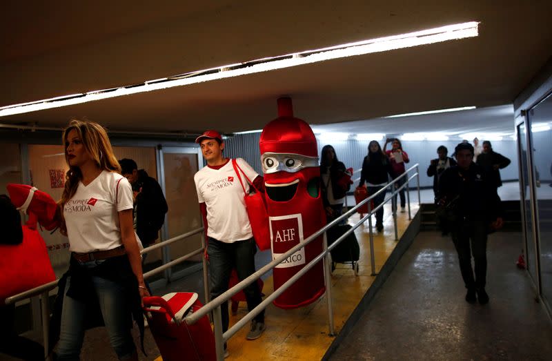 A man carries a condom costume inside the metro on International Condoms Day, celebrated a day before Valentine Day, in Mexico City