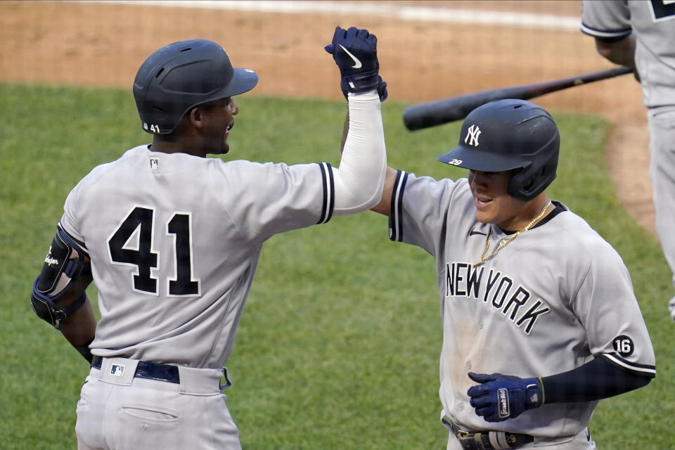 New York Yankees' Miguel Andujar (41) congratulates Gio Urshela on his solo home run off Minnesota Twins pitcher J.A. Happ (33) during the fourth inning of a baseball game Thursday, June 10, 2021, in Minneapolis. (AP Photo/Jim Mone)