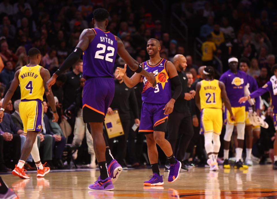 Dec 19, 2022; Phoenix, Arizona, USA; Phoenix Suns center Deandre Ayton (22) celebrates a play with guard Chris Paul (3) against the Los Angeles Lakers in the first half at Footprint Center. Mandatory Credit: Mark J. Rebilas-USA TODAY Sports