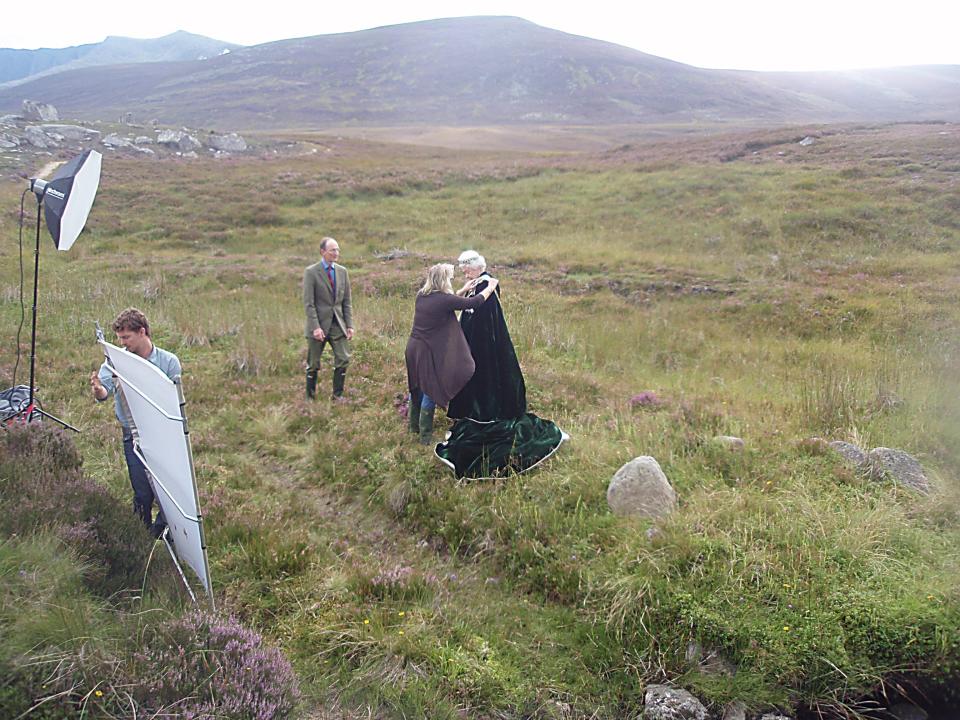 Kelly attends to Queen Elizabeth II during a photoshoot on moors near Balmoral in Scotland.