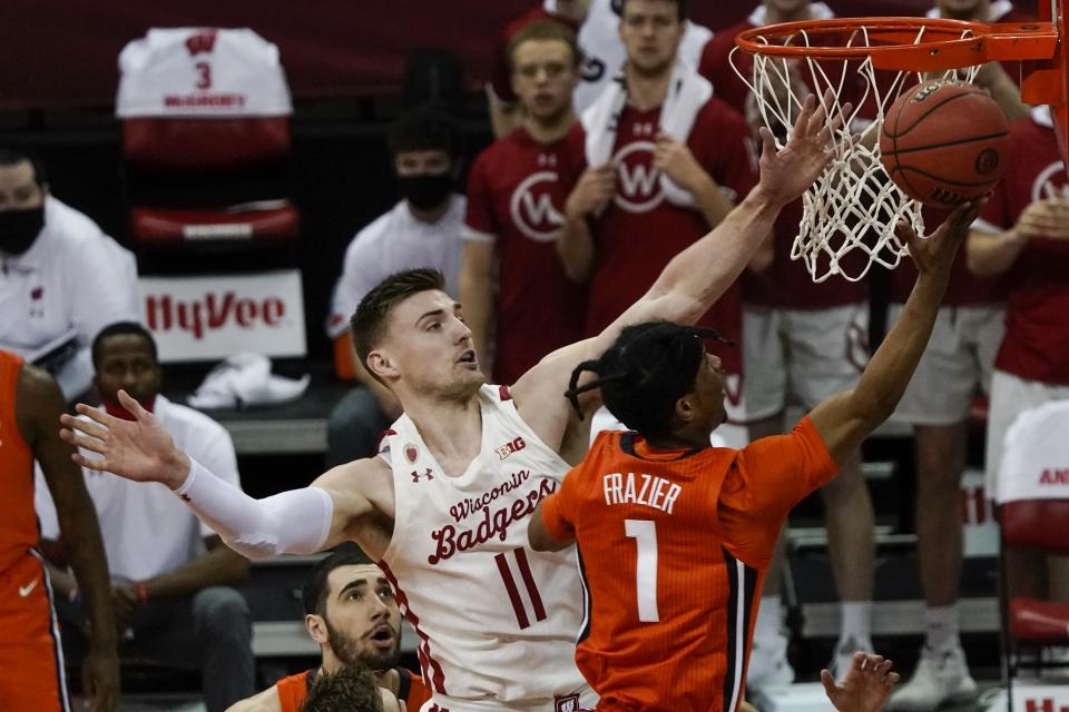 Illinois's Trent Frazier shoots past Wisconsin's Micah Potter during the first half of an NCAA college basketball game Saturday, Feb. 27, 2021, in Madison, Wis. (AP Photo/Morry Gash)