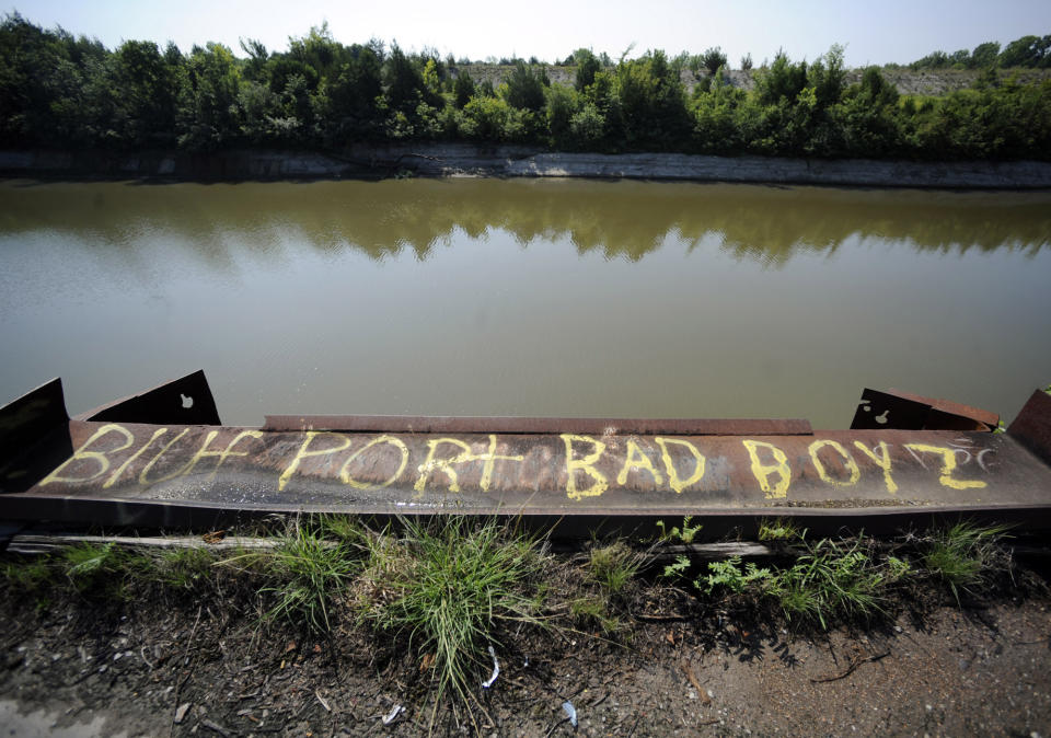 In this Thursday, July 9, 2019 photo, graffiti mars the scene beside an unused barge slip on the Tennessee-Tombigbee Waterway in Epes, Ala. While some places along the waterway have prospered in the more than 30 years since it opened with promises of development, tiny Epes is poor and mostly unchanged and has an unused port. (AP Photo/Jay Reeves)