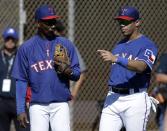 Seattle Seahawks quarterback Russell Wilson, right, talks with Texas Rangers manager Ron Washington on a practice field as the team takes batting practice during spring training baseball practice, Monday, March 3, 2014, in Surprise, Ariz. (AP Photo/Tony Gutierrez)