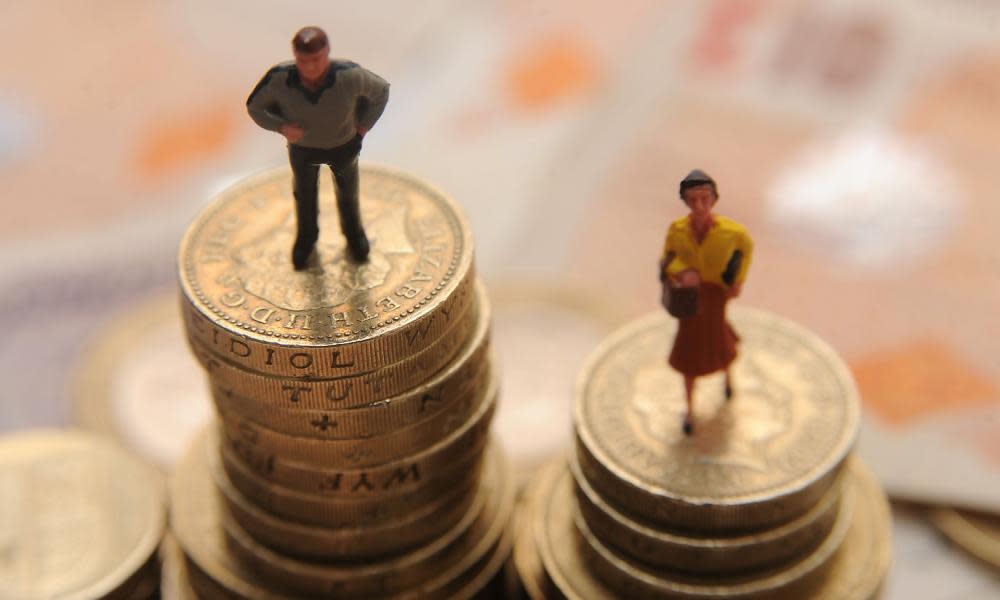 Plastic models of a man and woman standing on a pile of coins and bank notes