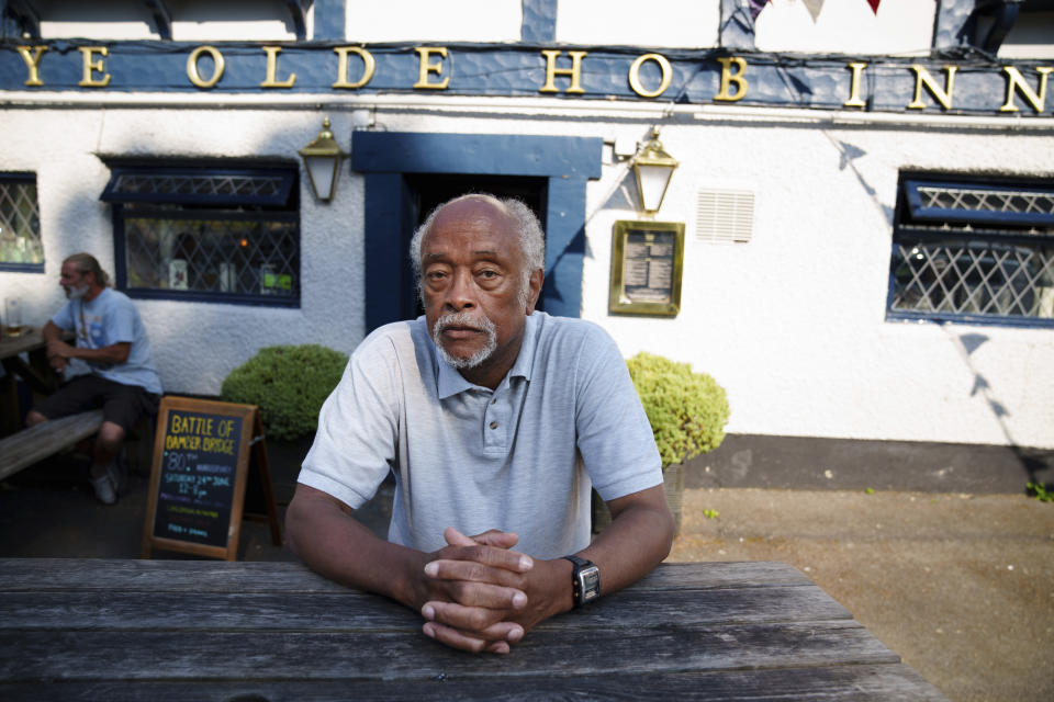 Clinton Smith, chair of Preston Black History Group is seen by the Ye Olde Hob Inn in Bamber Bridge near Preston, England, Thursday, June 22, 2023. What is now known as the Battle of Bamber Bridge erupted there on June 24, 1943 when white military police officers confronted black soldiers enjoying a night off in the local pub. (AP Photo/Jon Super)