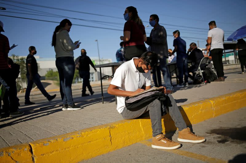 A job seeker fills out job application forms for assembly factories as the coronavirus disease (COVID-19) outbreak continues in Ciudad Juarez