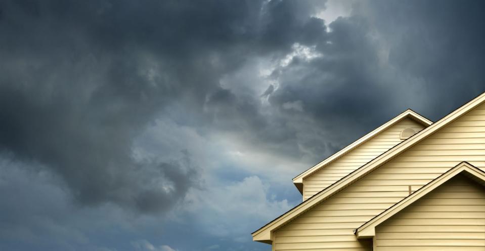 House Roof with Storm Clouds Above