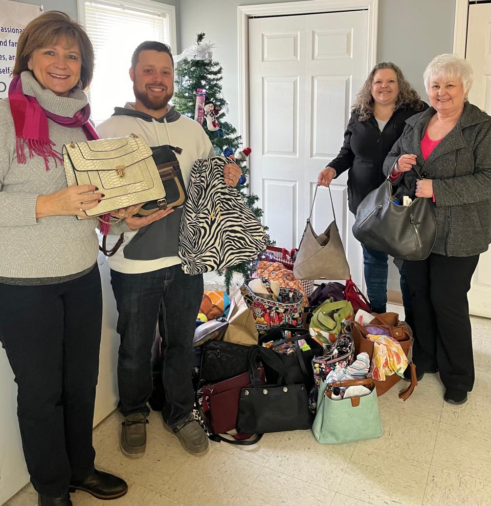 Devin Durain (second from left), executive director Heart of Ohio Homeless Shelter, accepts 40 Handbags for Hope delivered by Marion Women’s Club officers, Valerie Wigton, left, president; Lynette McCullough, vice president; and Pam DeGood, secretary.