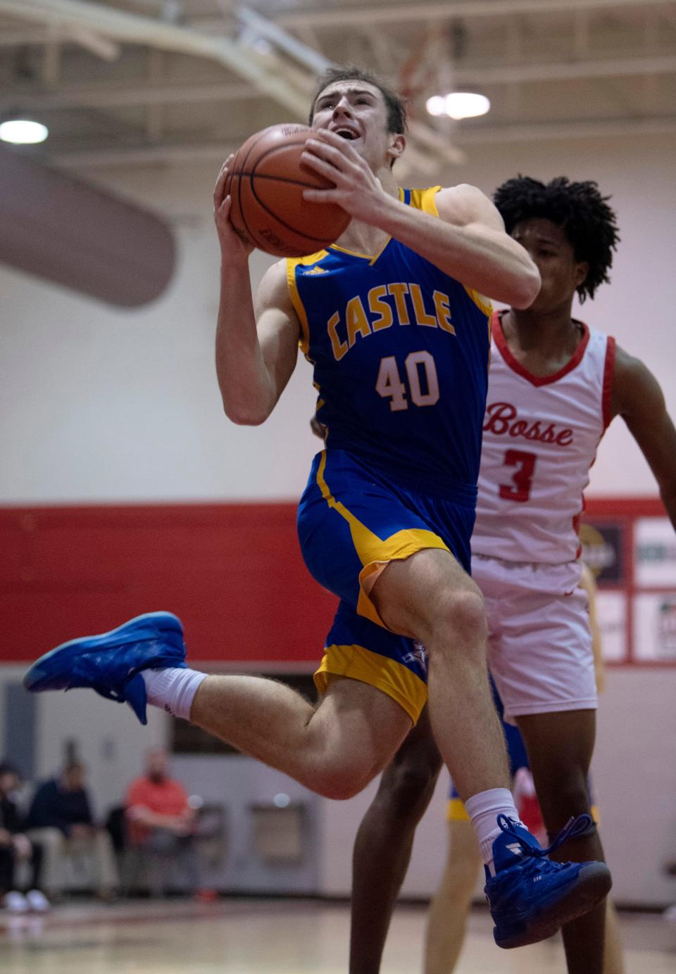 Castle's Weston Aigner (40) shoots while guarded by Bosse's Elijah Wagner (3) during their game at Bosse High School Thursday night, Feb. 2, 2023.