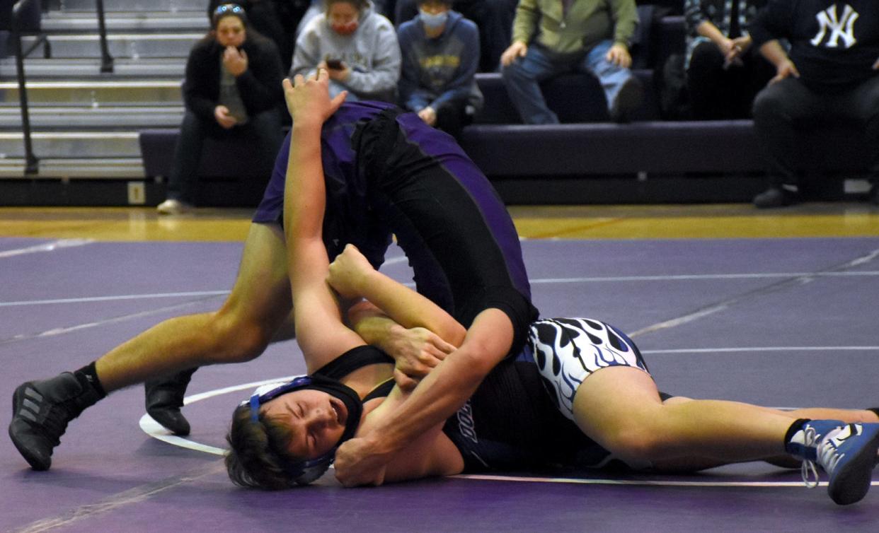 Little Falls Mountie Connor Baylor works to force Dolgeville Blue Devil Gabe Herringshaw (facing camera) onto his back during their 160-pound bout Thursday in Little Falls. Baylor led 18-4 before taking down Herringshaw for the last time and pinning him in the third period.