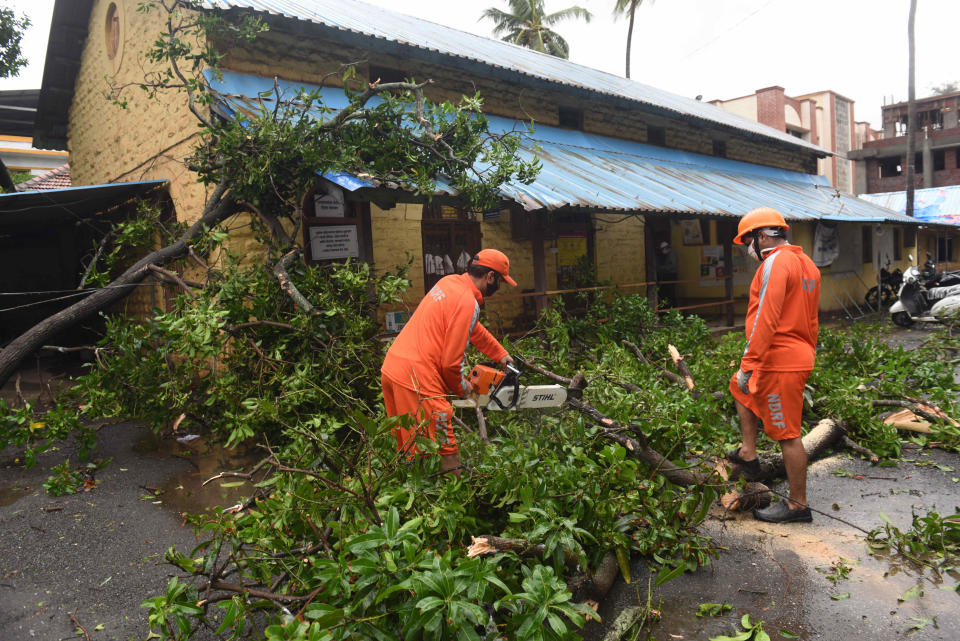 ALIBAUG, INDIA - JUNE 3: NDRF team cutting trees fallen on house at Alibag beach due Nisarga Cyclone landfall on June 3, 2020 in Alibaug, India. Alibaug witnessed wind speeds of up to 120 kilometres per hour. Although the cyclone made the landfall just 95 kilometres from Mumbai, the Maharashtra capital largely escaped its wrath. (Photo by Satish Bate/Hindustan Times via Getty Images)