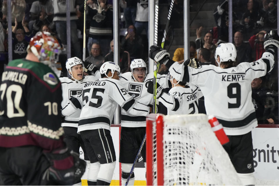 Los Angeles Kings center Anze Kopitar, middle, celebrates with teammates after scoring a goal against the Arizona Coyotes during the third period of an NHL hockey game Friday, Oct. 27, 2023, in Tempe, Ariz. (AP Photo/Rick Scuteri)