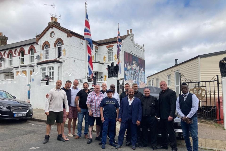 Courtney and a group of people outside his south east London home dubbed Camelot Castle (Dave Courtney Twitter)