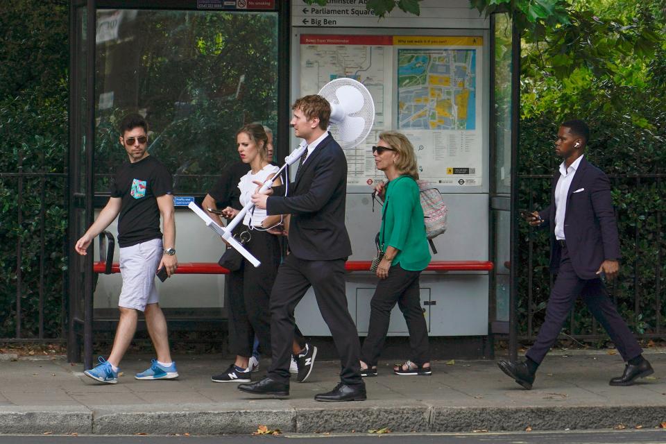 A man carries a fan as he walks in London (AP Photo/Alberto Pezzali)