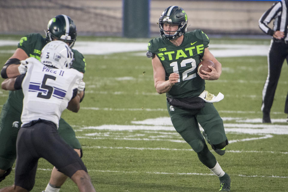 EAST LANSING, MI - NOVEMBER 28: Rocky Lombardi #12 of the Michigan State Spartans scrambles against the Northwestern Wildcats during the second quarter at Spartan Stadium on November 28, 2020 in East Lansing, Michigan. (Photo by Nic Antaya/Getty Images)