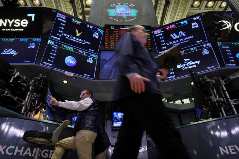 Traders work on the floor of the NYSE in New York