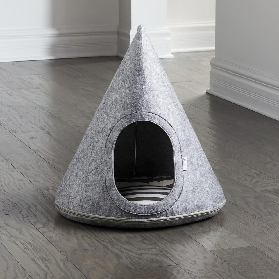 This photo provided by Crate and Barrel shows the company's Nooee Toby Pet Cave. No longer are furniture companies content to offer you staples like a sofa, easy chair and bed. Now they have those items for your pet, too, designed not to clash with the rest of your decor. Pottery Barn, Crate and Barrel, Ikea, Casper mattresses and other popular furniture purveyors have lines for pets, often in styles that complement their human-size living room furniture. (Crate and Barrel via AP)