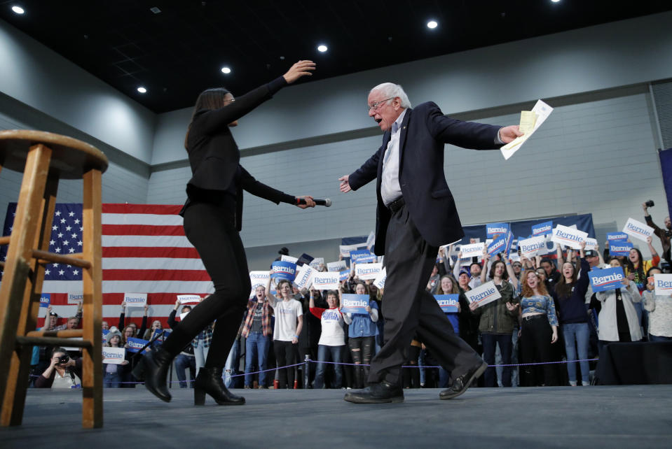 Democratic presidential candidate Sen. Bernie Sanders, I-Vt., right, embraces Rep. Alexandria Ocasio-Cortez, D-NY, at a campaign rally Sunday, Jan. 26, 2020, in Sioux City, Iowa. (AP Photo/John Locher)