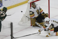 Vegas Golden Knights goalie Marc-Andre Fleury (29) blocks the puck with his body after Minnesota Wild's Nick Bjugstad (27) tried to make a goal in the third period of an NHL hockey game Monday, March 8, 2021, in St. Paul, Minn. (AP Photo/Stacy Bengs)