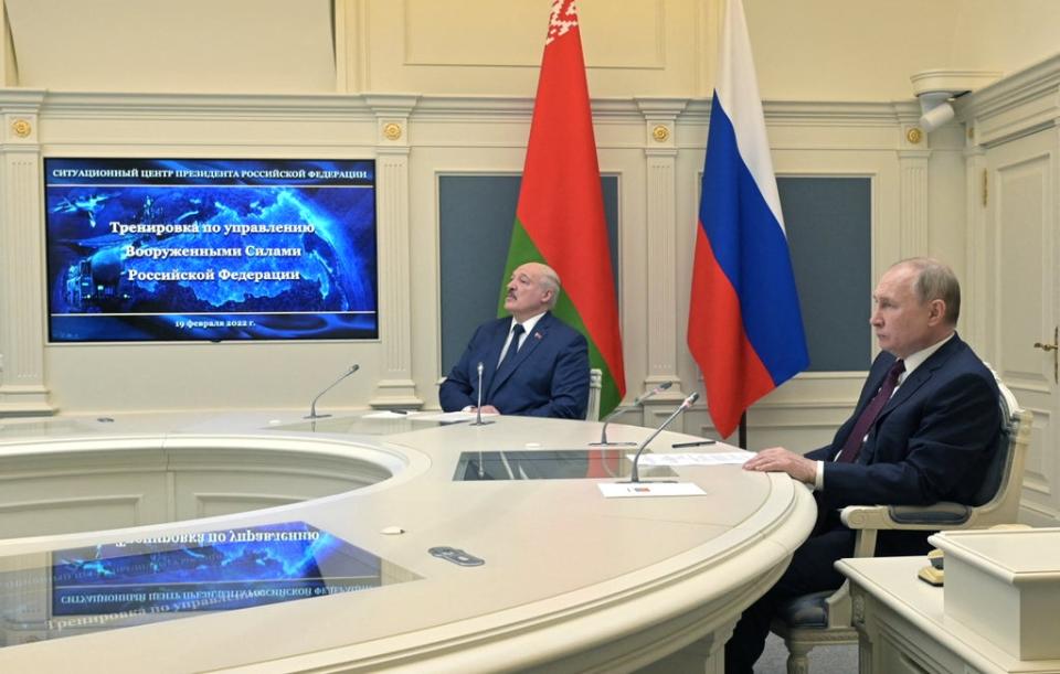 File photo: Mr Putin and Mr Lukashenko watch training launches of ballistic missiles from the situational centre of the Russian defence ministry in Moscow, 19 February 2022 (Sputnik/AFP via Getty Images)