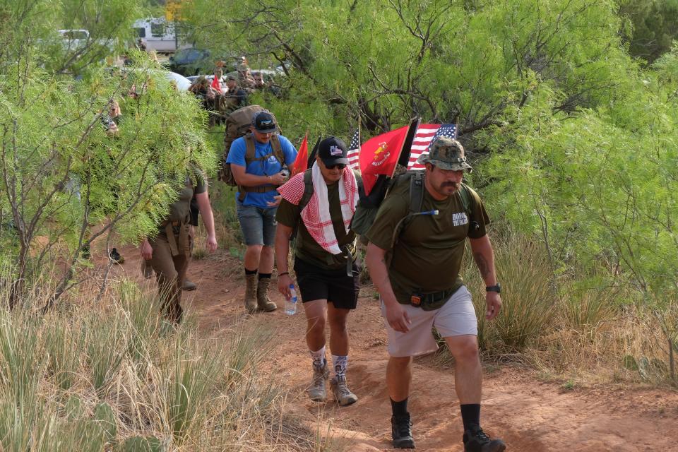 Hikers start the first leg of the 10-mile " Memorial Day Hike"  Sunday morning at Palo Duro Canyon.