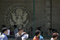 <p>Visa applicants wait to enter the U.S. Embassy near the site of an explosion in Beijing, Thursday, July 26, 2018. A man exploded a small homemade bomb outside the U.S. Embassy, injuring only himself, according to police and an embassy spokesperson. (Photo: Ng Han Guan/AP) </p>