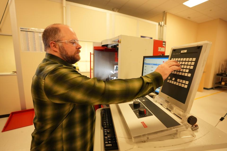 Kurt Douglas, Program Coordinator and Instructor (ACM/CNC/NDT) programs works with CNC equipment at the Colleges campus in Portsmouth.