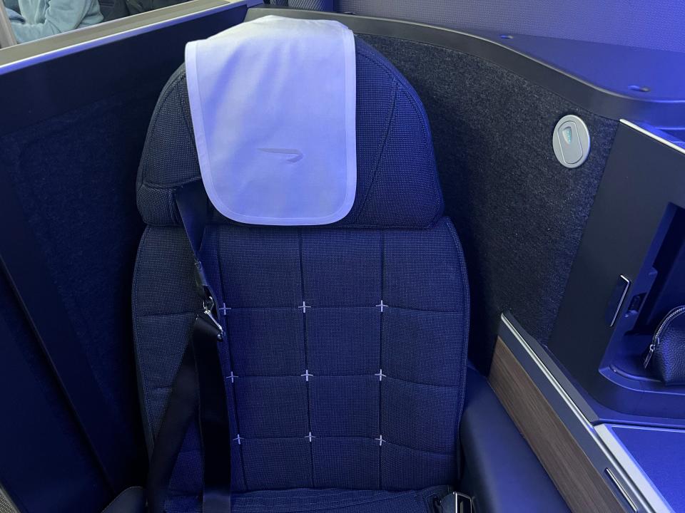 The author's black business class seat.