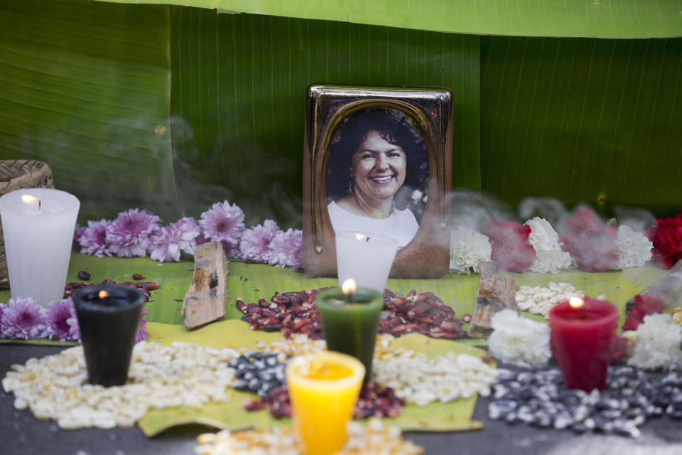 FILE - In this June 15, 2016, file photo, a picture of Berta Caceres sits on an altar in her honor during a demonstration outside Honduras' embassy in Mexico City. Activists demanded justice after the murder of Caceres, a Lenca Indian activist who won the 2015 Goldman Environmental Prize for her role in fighting a dam project. She was shot dead by two men on March 3. Global Witness said Tuesday, July 24, 2018 that at least 207 people who were protecting land and resources from business interests were slain last year. (AP Photo/Eduardo Verdugo)