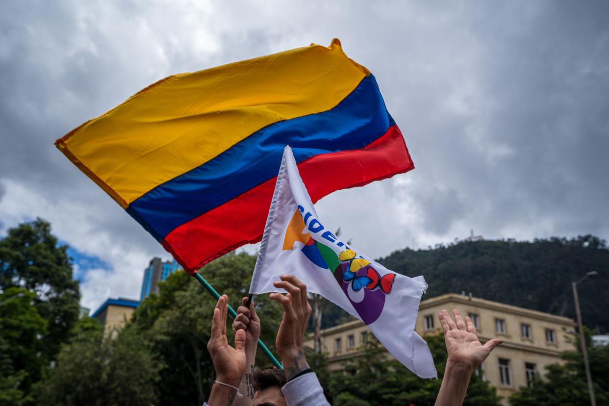 People shake Colombian and Gustavo Petro flags on August 7, 2022 in Bogota, Colombia. Leftist leader was elected president in a tight runoff against Rodolfo Hernandez on June 19.