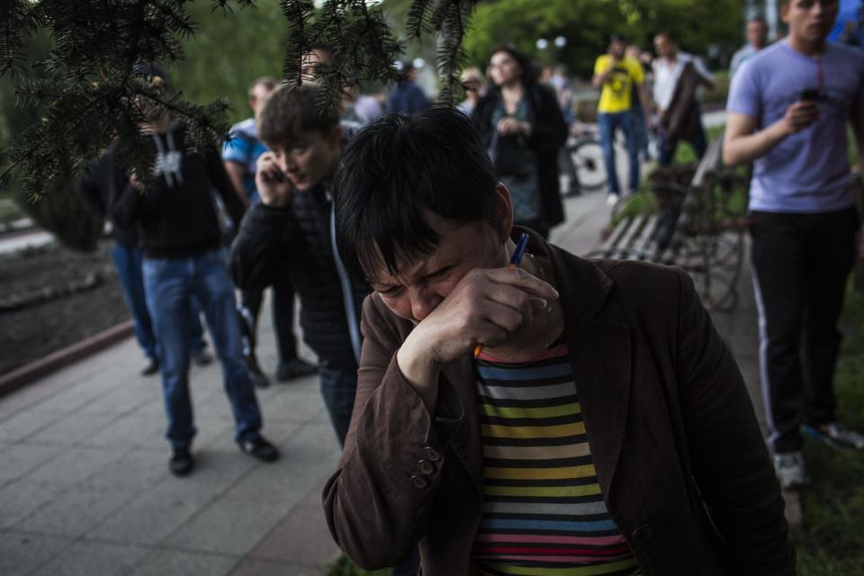 A woman reacts after Ukrainian national guardsmen opened fire on a crowd outside a town hall in Krasnoarmeisk, about 30 kilometers (20 miles) from the regional capital, Donetsk, Ukraine, Sunday, May 11, 2014. Although the voting in the Donetsk and Luhansk regions appeared mostly peaceful, Ukrainian national guardsmen opened fire on a crowd outside a town hall in Krasnoarmeisk, and an official with the region’s insurgents said there were fatalities. (AP Photo/Manu Brabo)