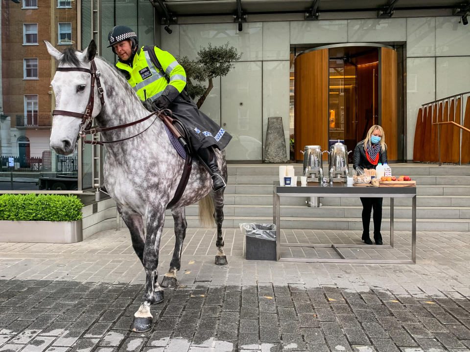 A police horse arrives at a free drive-through for the emergency services at The Berkeley Hotel as the UK continues in lockdown to help curb the spread of the coronavirus.