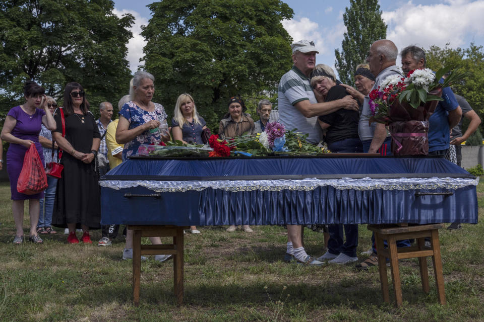 FILE The mother of 40-year-old Volodymyr Miroshnychenko who was killed on the frontlines of Marinka, weeps during his funeral procession at a cemetery in Pokrovsk, eastern Ukraine, Friday, July 15, 2022. Ukrainians living in the path of Russia's invasion in the besieged eastern Donetsk region are bracing themselves for the possibility that they will have to evacuate. The mayor of Pokrovsk is mentally preparing for a military-ordered evacuation in which he would be among the last to leave. (AP Photo/Nariman El-Mofty, File)