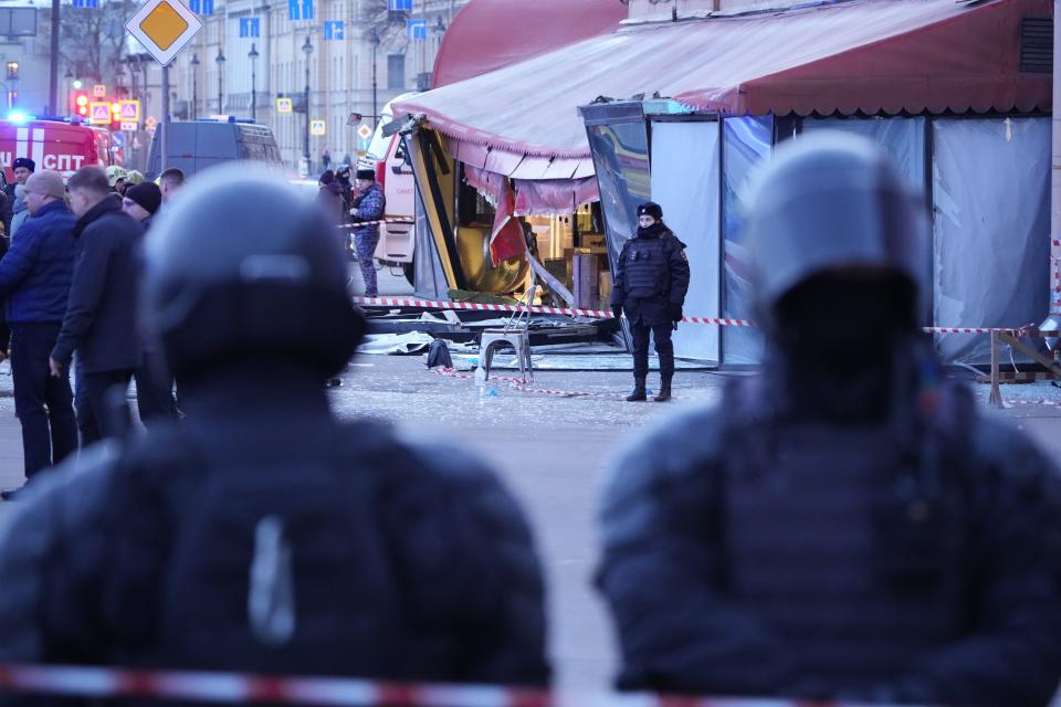 Russian police officers are seen at the site of an explosion at a cafe in St. Petersburg, Russia, Sunday, April 2, 2023. An explosion tore through a cafe in the Russian city of St. Petersburg on Sunday, and preliminary reports suggested a prominent military blogger was killed and more than a dozen people were injured. (AP Photo)